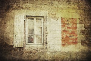 An old French window and a bricked up window